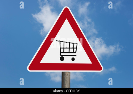 Detail photo of a danger sign with a shopping cart in the middle, background sky. Stock Photo