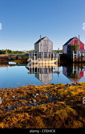 Dories reflected in water at low tide, Blue Rocks, Lunenburg, Nova Scotia, Canada Stock Photo