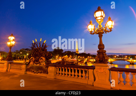 Eiffel Tower as seen from the Pont Alexandre III (Alexander III Bridge) at night, Paris, France, Europe Stock Photo