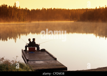 Boys fishing on dock, Duck Mountain Provincial Park, Manitoba, Canada Stock Photo