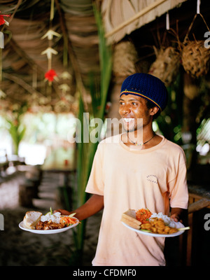 Waiter at restaurant Loutier Coco on Grand Anse beach, south eastern La Digue, La Digue and Inner Islands, Republic of Seychelle Stock Photo