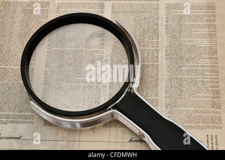 a magnifying glass is on a very small print terms and conditions Stock Photo
