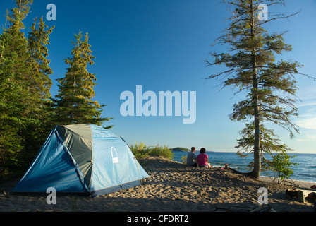 Couple with tent on beach, Agawa Bay, Lake Superior Provincial Park, Ontario, Canada Stock Photo