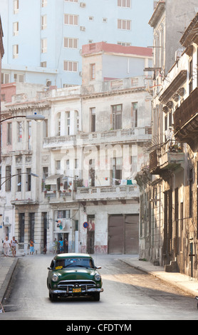 Classic American car taxi driving down quiet street in Havana Centro, Havana, Cuba, West Indies, Central America Stock Photo