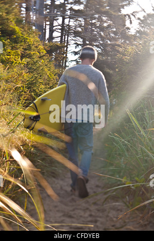 A male surfer checks out early morning conditions, Pacific Rim National Park, Tofino, British Columbia, Canada Stock Photo