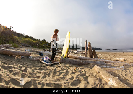 A male surfer checks out early morning conditions, Pacific Rim National Park, Tofino, British Columbia, Canada Stock Photo