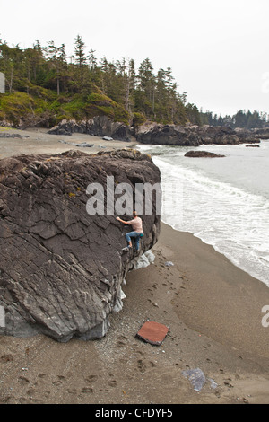 A man bouldering along the coast of Ucluelet, near Pacific Rim National Park, British Columbia, Canada Stock Photo