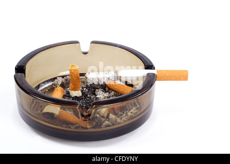A flithy glass ash-tray photo on the white background Stock Photo