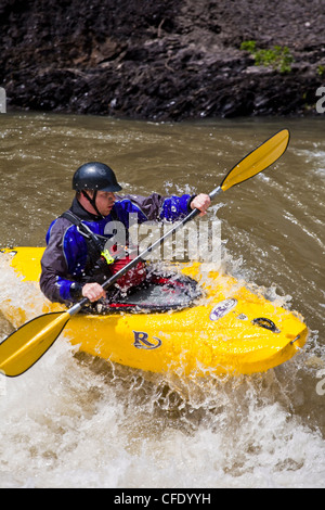A man whitewater kayaking through a challenging rapid. Highwood River, Alberta, Canada Stock Photo