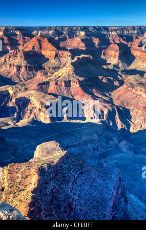 Landscape of brown and tan rock formations at water at Watson Lake Park ...