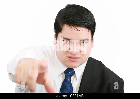 Portrait of an angry young business man in suit pointing at you isolated over white background Stock Photo