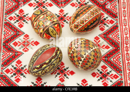 Romanian painted Easter eggs on a traditional towel. Stock Photo