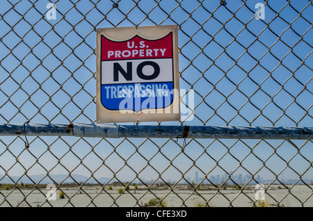 US property No Trespassing sign at Naval Air Station Alameda with San Francisco Skyline in the distance. Stock Photo