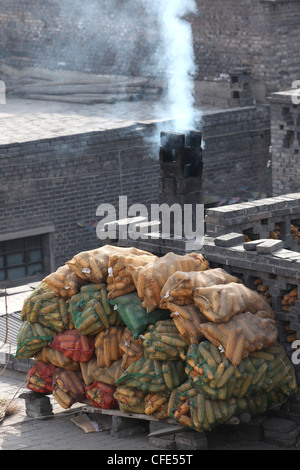 roof smoke, pollution,Pingyao, Qing dinasty old town, Shanxi province, China Stock Photo