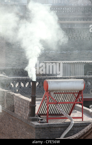 roof smoke, pollution,Pingyao, Qing dinasty old town, Shanxi province, China Stock Photo