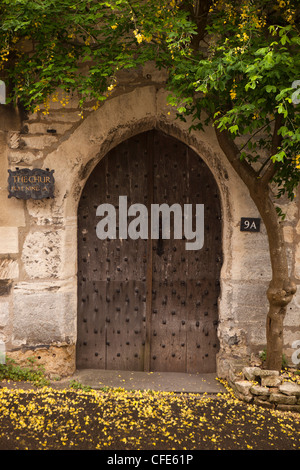 UK, Gloucestershire, Stroud, Painswick, Bisley Street, medieval arched entrance to The Chur, historic C16th house Stock Photo