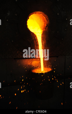 Foundry - molten metal poured from ladle for casting - still life Stock Photo