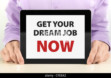 Manager holding tablet PC with 'Get Your Dream Job Now' text on screen. Stock Photo