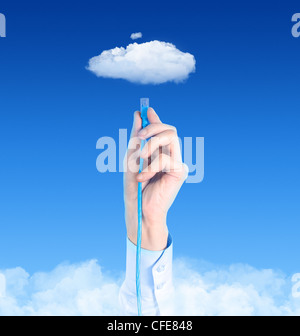 Hand with the cable connected to the cloud. Conceptual image on cloud computing theme. Stock Photo