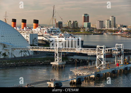 Queen Mary ocean liner docked at Port of Long Beach as seen from departing cruise ship-Long Beach, California, USA. Stock Photo