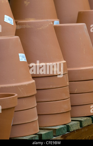 Terracotta plant pots stacked on top of each other on a shelf Stock ...