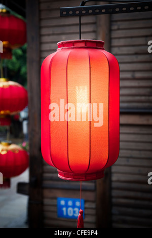 Hanging red lantern on the traditional wooden wall background in a Chinese market Stock Photo