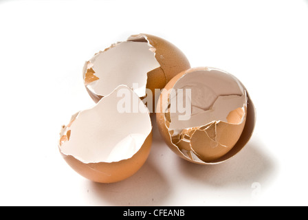Three broken, empty brown eggshells. Stock Photo