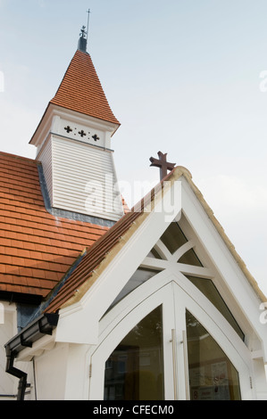 Close-up detail of porch, tiled roof & tower of St James’s Church (unique pretty little white timber building) - Baildon, West Yorkshire, England, UK. Stock Photo