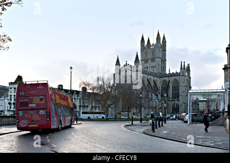 Tourist open topped bus and Bath Abbey, Bath, UK in early evening. Stock Photo