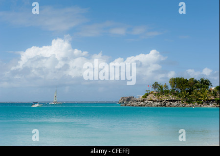 Boats on Caribbean Grand Case Saint Martin with blue sky clouds and palm trees Stock Photo