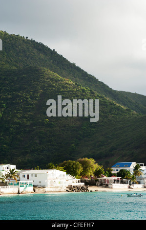 Mountains, Caribbean and buildings on the beach at Grand Case, Saint Martin Stock Photo