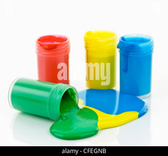 Open containers of paint in primary colors spilled and mixed Stock Photo