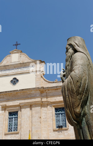 Statue of an Greek Orthodox priest in front of the Orthodox Cathedral in the beautiful Venetian harbour town of Chania. Stock Photo