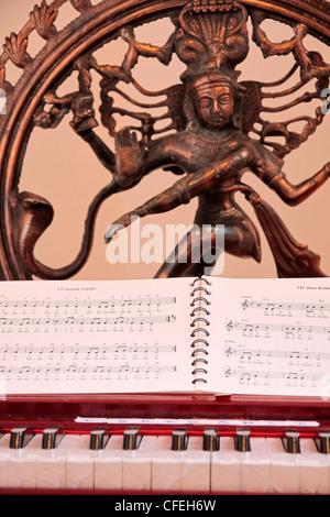 Harmonium, marks and Indian statue as a decoration in a yoga room Stock Photo