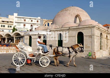 A horse and carriage in front of the multi domed waterfront Ottoman Mosque of the Janissaries Stock Photo