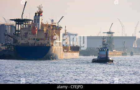Ships busy on the river on a misty morning at sunrise Stock Photo