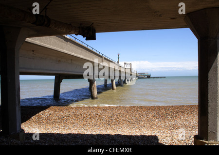 Deal pier, in Kent, with a yellow pebble beach. Stock Photo