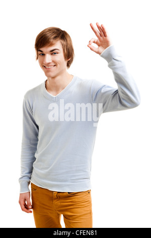 Portrait of a handsome young man doing a Okay gesture, isolated over a white background Stock Photo