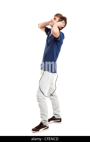 Portrait of a handsome young man dancing and listening music, isolated on white background Stock Photo