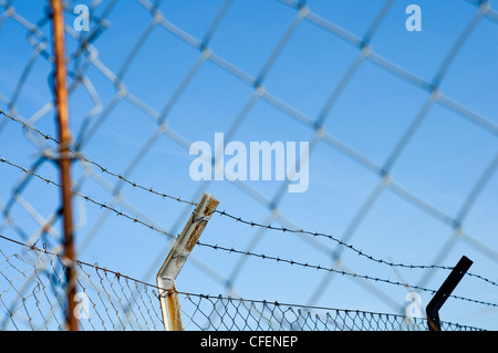 A section of security fencing and barbed wire Stock Photo