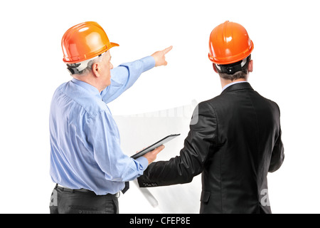 A team of construction workers with orange helmets posing isolated on white background Stock Photo