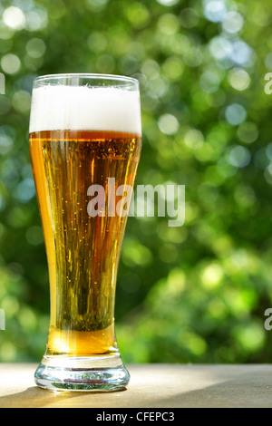 Beer glass at the table close-up, background is out of focus Stock Photo