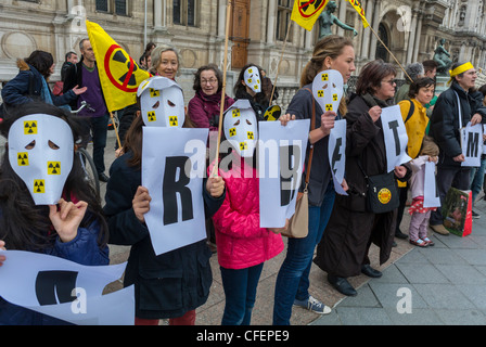 Paris, France, Anti Nuclear Power Activists Demonstrating on Anniversary of Fukushima Disaster, Children in Masks, Holding Climate Protest signs Stock Photo