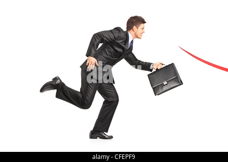 Businessman with a briefcase running towards a finish line isolated on white background Stock Photo