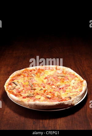 Pizza on a wooden table Stock Photo