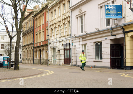Street Cleaner collecting litter in Cardiff Bay, South Wales, UK Stock Photo