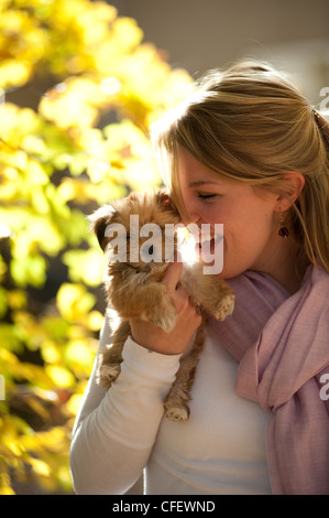 A beautiful young woman with her puppy. Stock Photo
