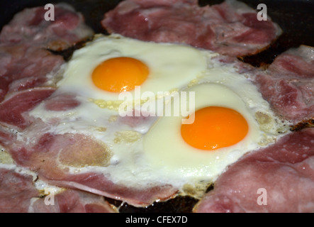 bacon and eggs cooking Stock Photo