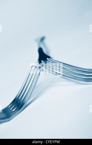 Steel forks in modern blue Stock Photo