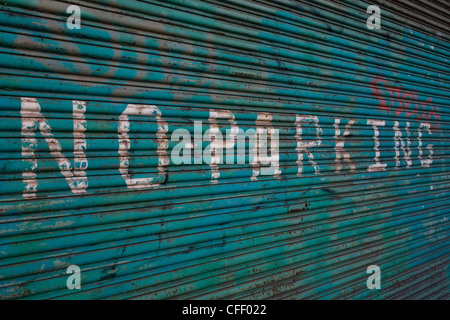 A hand-painted No Parking notice on derelict shutters near 2012 Olympic Park site. Stock Photo